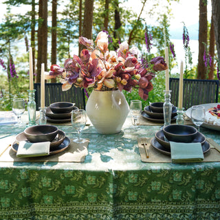 Table setting with floral centerpiece in a forested area