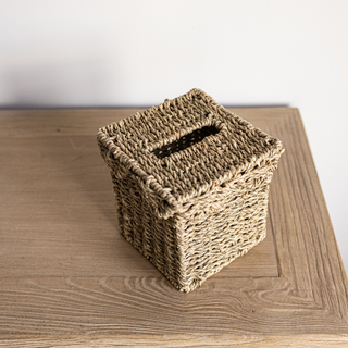 Woven tissue box cover on a wooden surface
