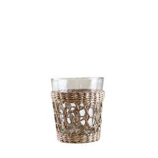 Clear glass tumbler with wicker-style外围 on a white background