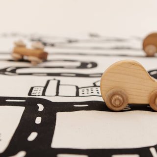 Wooden toy cars on a road map