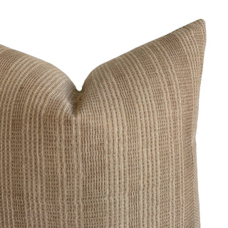Textured beige pillow on a white background