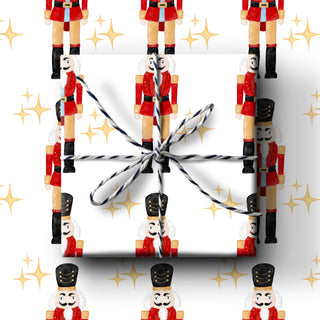 Gift box with ribbon on a background of nutcracker soldiers and gold stars