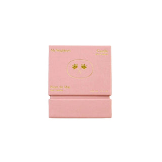Pink jewelry box with gold accents on a light background