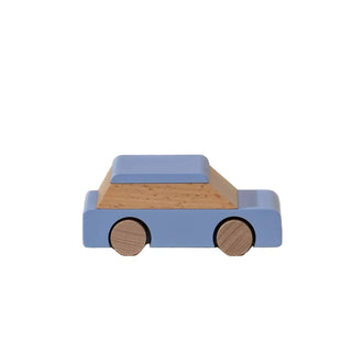 Wooden toy car with blue body and brown wheels on a beige background