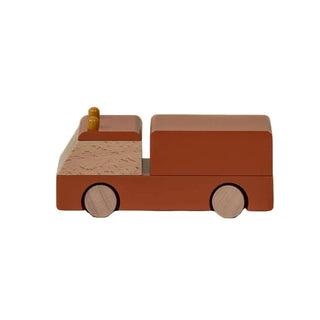 Wooden toy car on a beige background