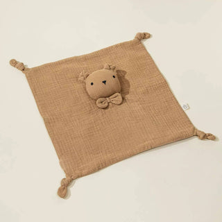 Brown textured square with a plush toy on a beige background
