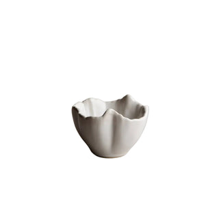 Small ceramic bowl on a plain surface with a neutral background