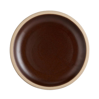 Brown ceramic plate with beige rim on a light gray background