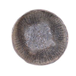 Vintage wicker bowl with textured surface on a white background