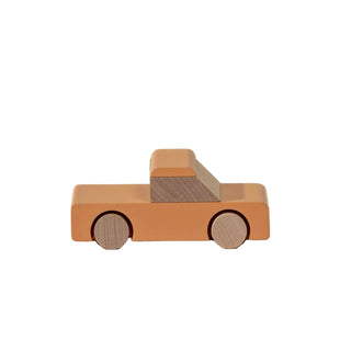 Wooden toy truck on a beige background