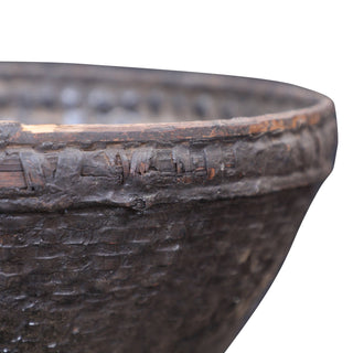 Close-up of a textured wicker bowl on a white background