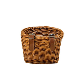 Wicker basket with leather straps on a beige background