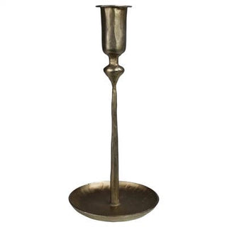 A large brass-plated metal candleholder with a fluted design and a wide bottom plate.
