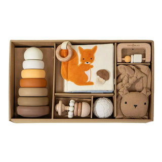 Set of baby toys in a box with a fox design on a neutral background