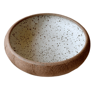 Speckled ceramic bowl on a white background