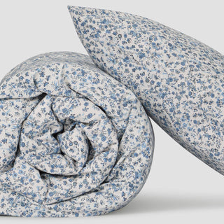 Floral patterned duvet and pillow on a light gray background