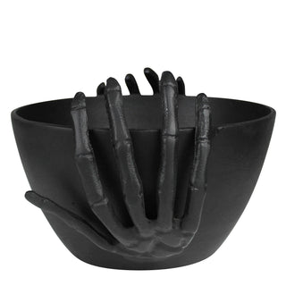 Halloween black bowl with skeleton hand design on a white background