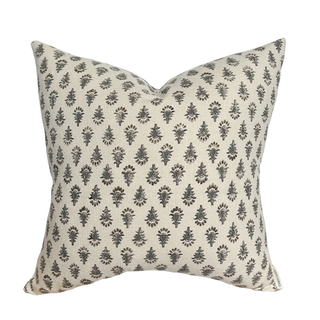 Decorative pillow with a subtle pattern on a beige background