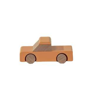 Wooden toy truck on a beige background