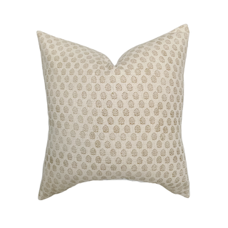 Decorative pillow with a subtle pattern on a beige background