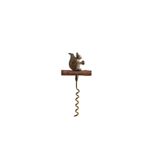 A vintage-style metal corkscrew with a small squirrel figurine on top of a wooden handle, photographed against a textured off-white background.