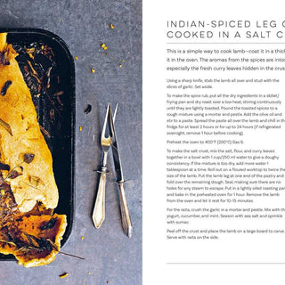 Cooked leg of lamb in a salt crust on a tray with text on the side.