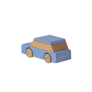 Wooden toy car with blue top and brown body on a beige background