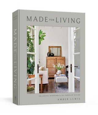 A cover image of the book titled 'MADE FOR LIVING' by Amber Lewis, featuring a photograph of a room with decorative pillows, furniture, and a large window.