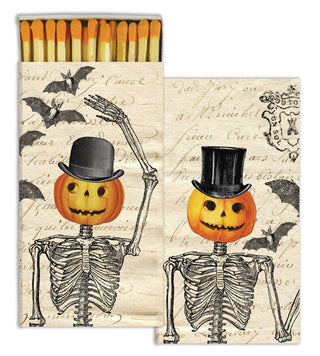 Matches with skeletons and pumpkins wearing top hats on a vintage-style matchbox.