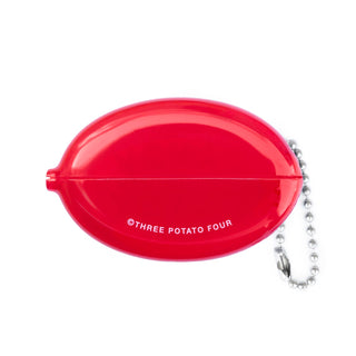 Red oval container with 'Three Potato Four' text and a chain on a white background