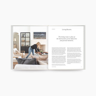 Open book showing a living room scene with a woman and text on a white background