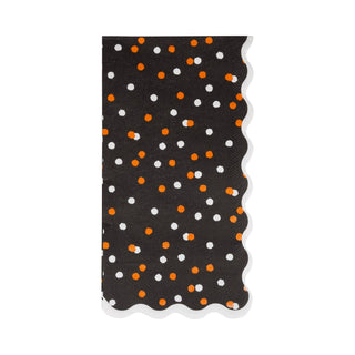 Black napkin with orange and white polka dot pattern on a white background