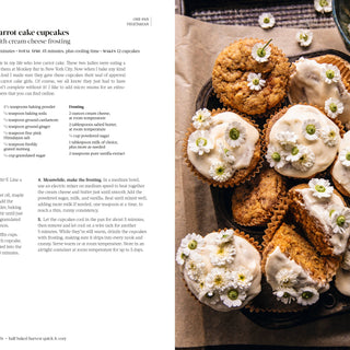 Carrot cake cupcakes with cream cheese frosting on a tray, alongside a recipe.