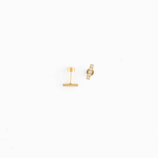 Gold earring on a white background