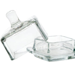 Clear glass butter dish with lid on a white background