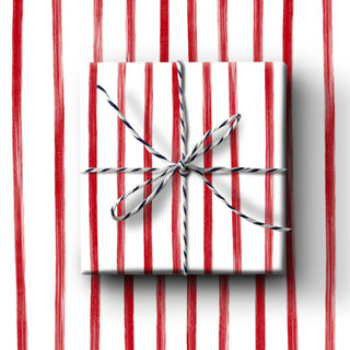 White gift box with a silver ribbon on a red and white striped background