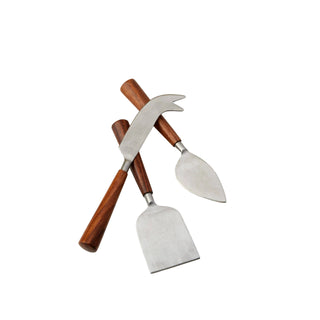 Three metal cheese knives with wooden handles on a marble surface