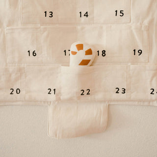 Beige fabric with numbers and a heart-shaped object on a beige background