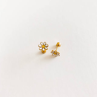 Gold flower-shaped earrings on a light gray background