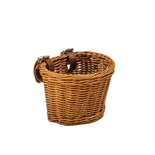 Wicker basket with leather handles on a beige background