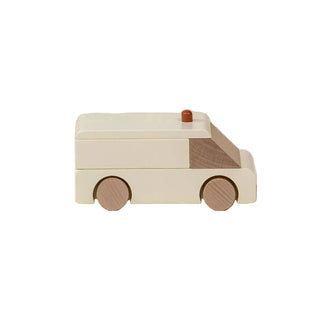 Wooden toy ambulance on a beige background