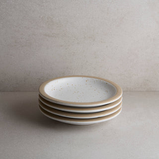 Stack of ceramic plates on a neutral background