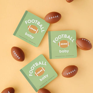 Three green 'Football Baby' books surrounded by small brown football-shaped toys on a yellow background