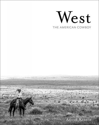 Book cover of 'West: The American Cowboy' by Anouk Krantz with a black and white photo of a cowboy on horseback in a vast landscape.