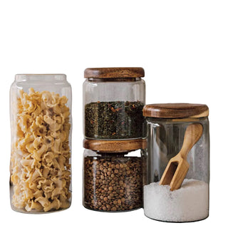 Set of glass jars with wooden lids on a kitchen counter