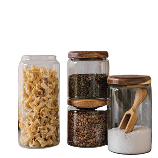 Set of glass jars with wooden lids on a kitchen counter