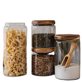Set of glass jars with wooden lids on a kitchen counter