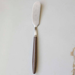 Butter knife with wooden handle on a light gray background