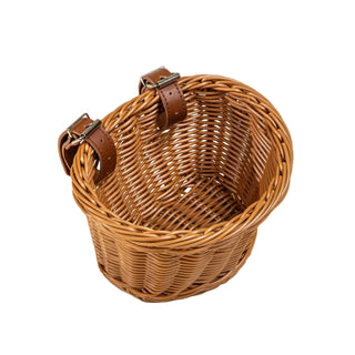 Wicker basket with leather straps on a beige background