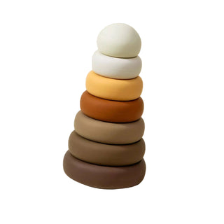Stack of colorful wooden rings on a beige background